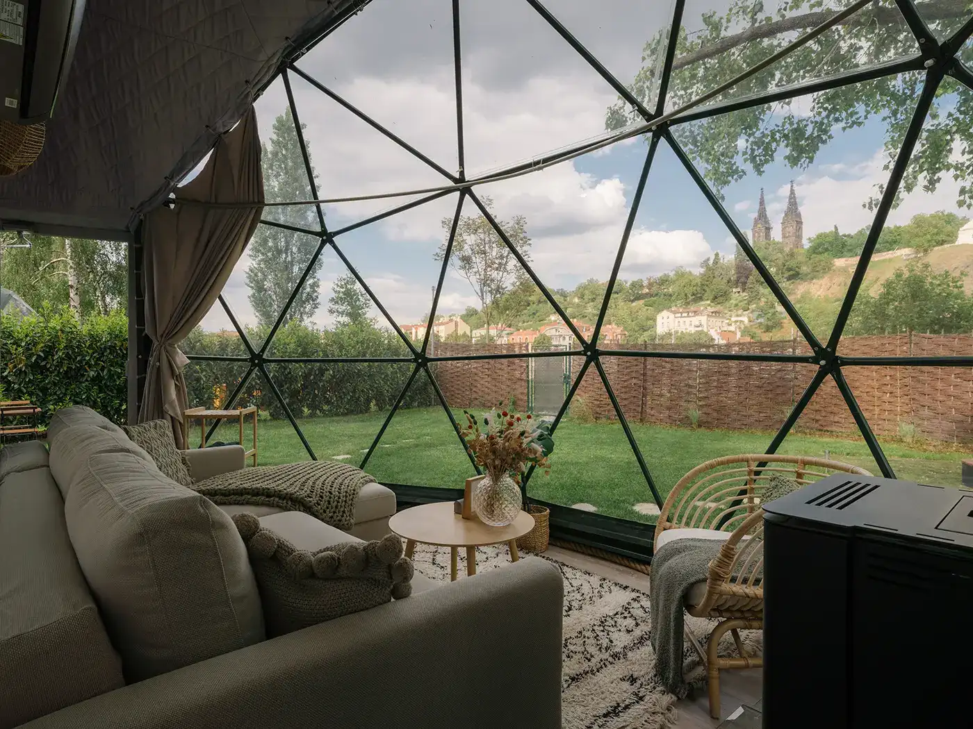 Inside the dome looking out through the glass facade to the garden and Vyšehrad