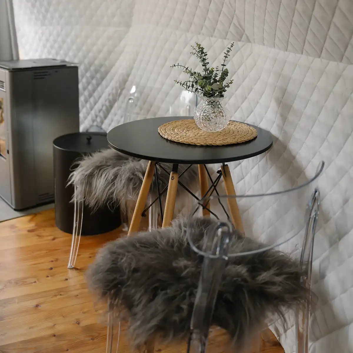 Morning inside the dome: knit blanket on the sofa, light through the glass panels