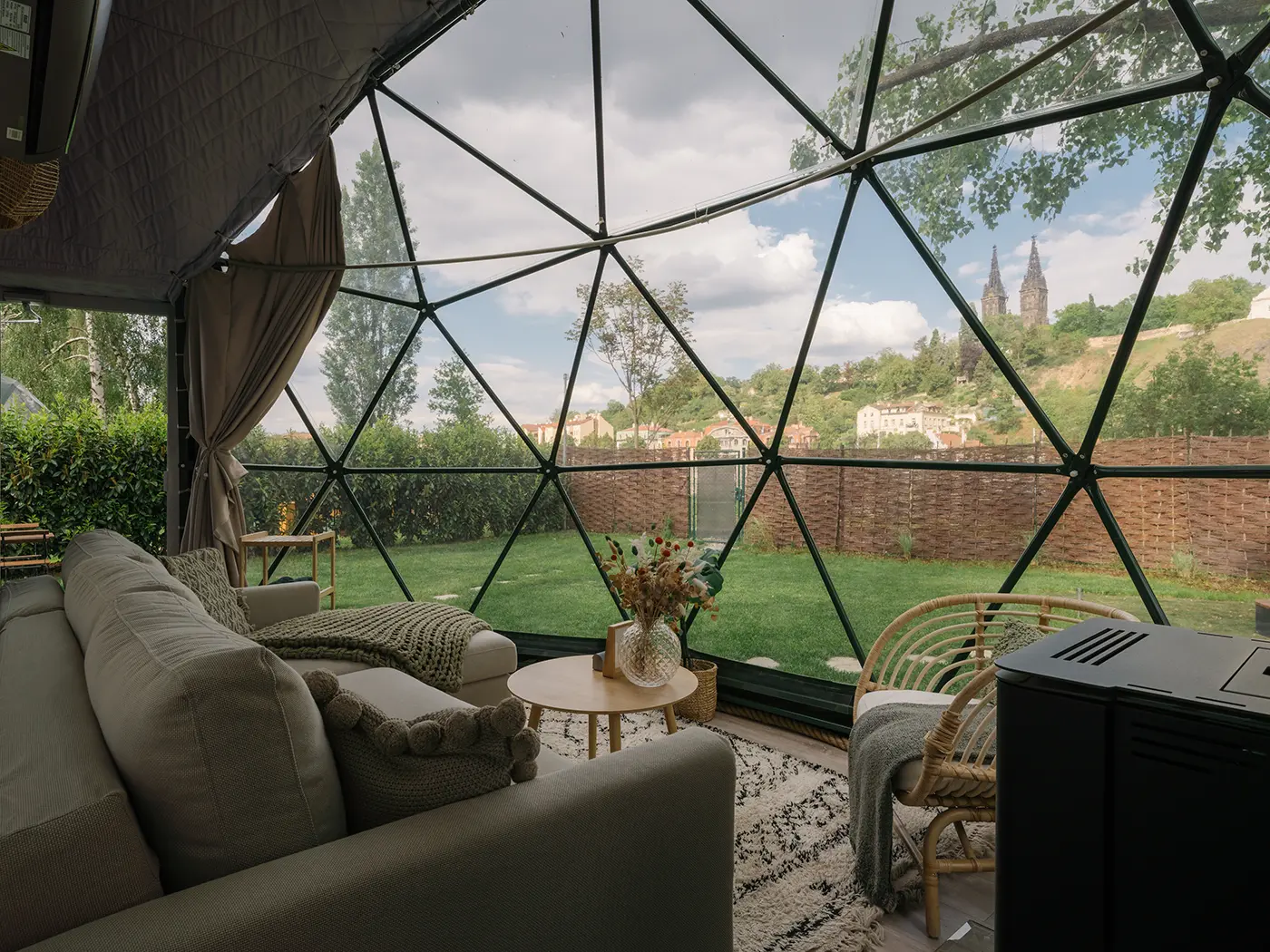Inside the dome looking out through the glass facade to the garden and Vyšehrad